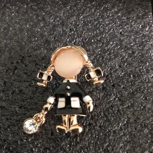 Girl in enamel black coat ponytails brooch